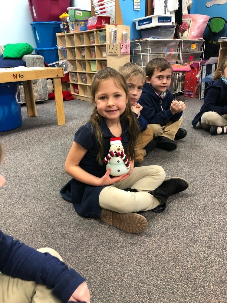 girl holding snowman