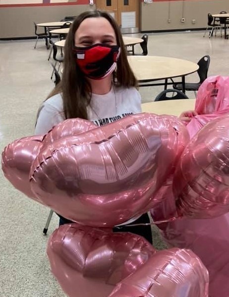 High school girl with pink balloons