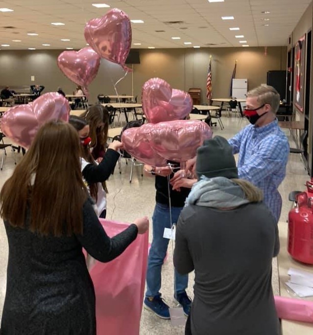 High school students bagging up balloons