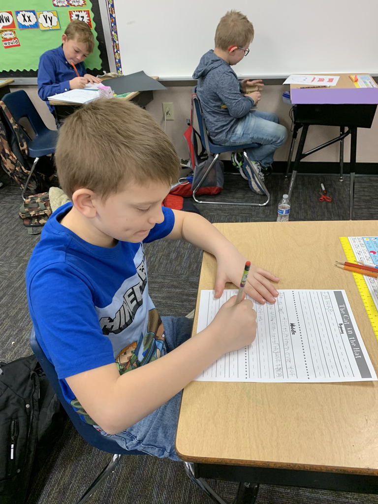 2nd grade boys focusing on a writing assignment