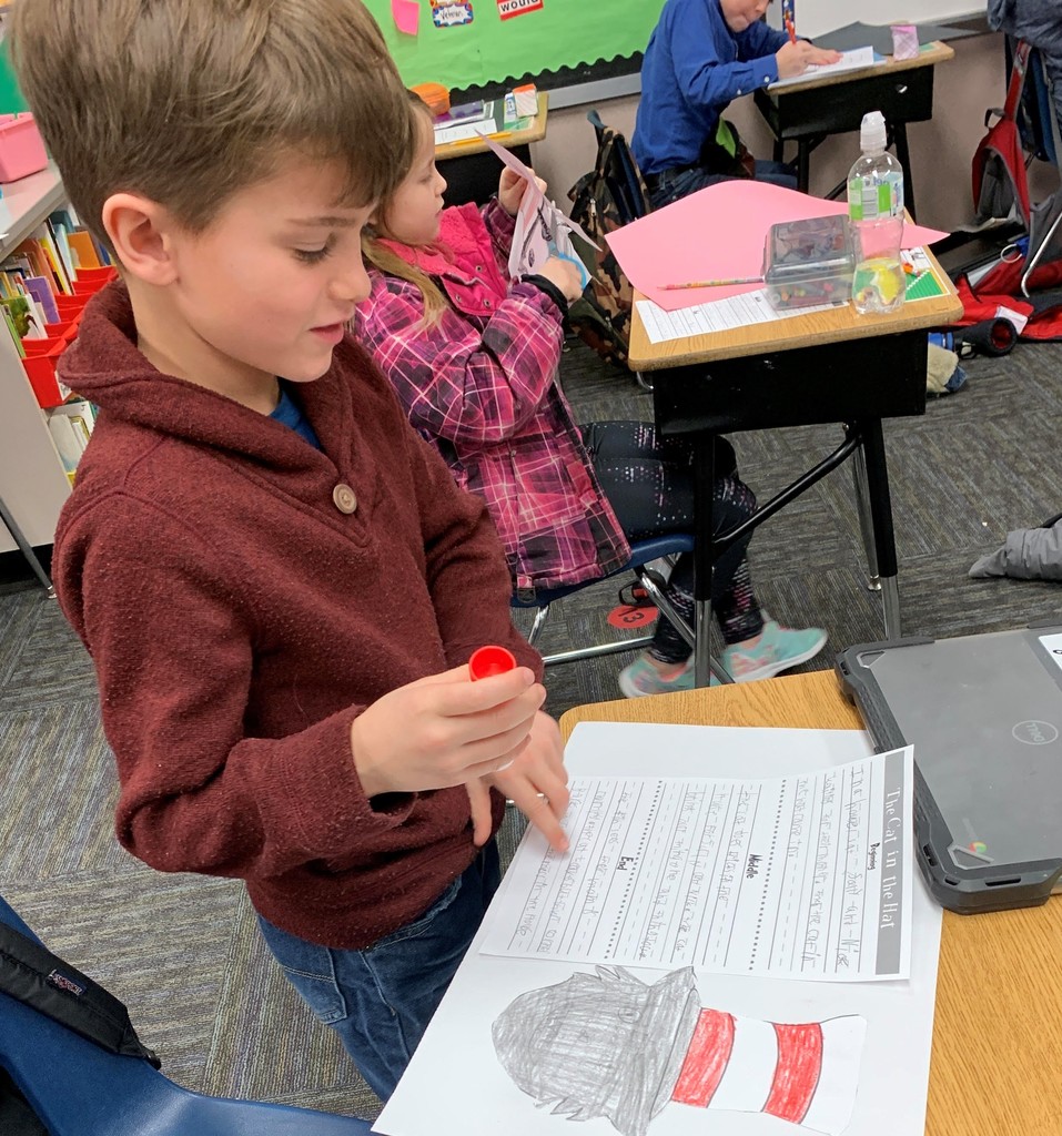 2nd grade boy works on writing assigment