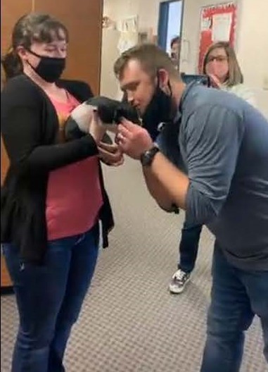 Teacher Markus Clancy kisses a pig