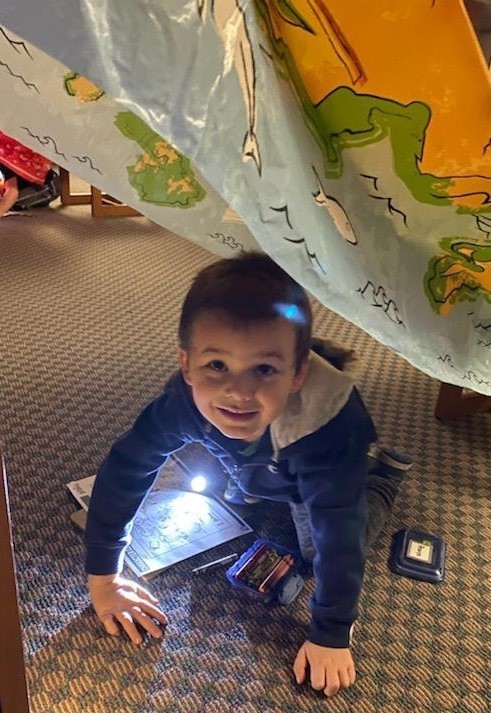 Smiling boy reading in library