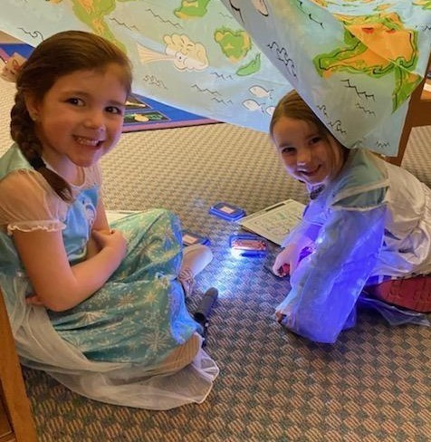 Two girls working on an assignment in a tent in the library