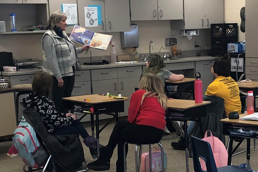 Lynn Bauer reads a book to the class