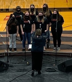 Choir members perform during concert