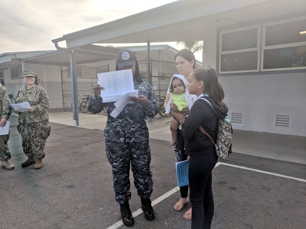 This amazing military volunteer is making sure a new 6th Grader gets to class on the first day.