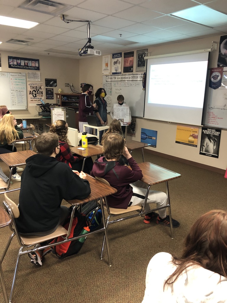 three male students presenting