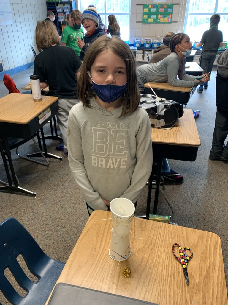 female with a mask near her desk