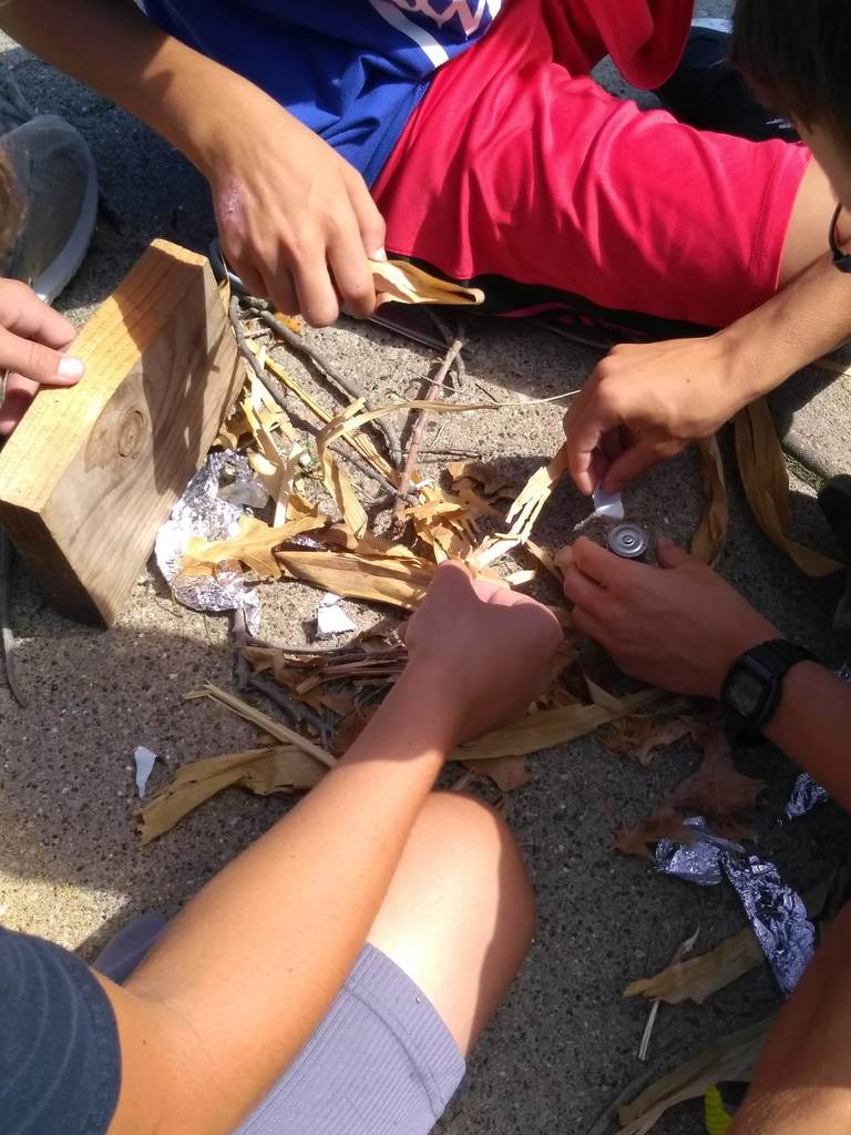 Outdoor Club students make a small survival fire