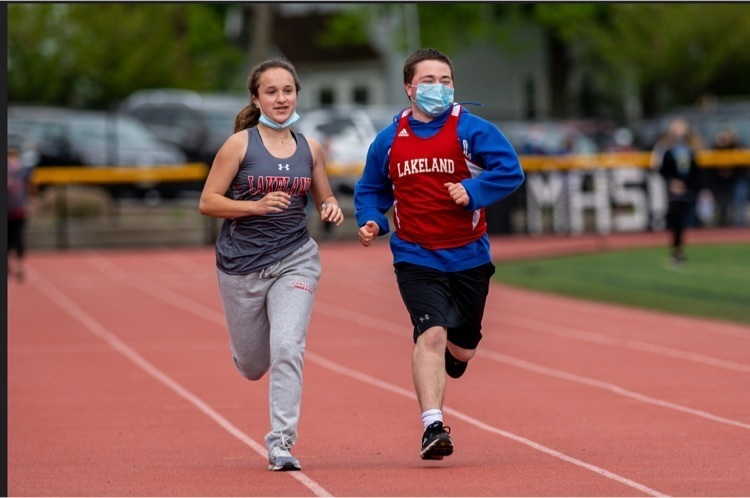 One of our athletes running with their unified partner!