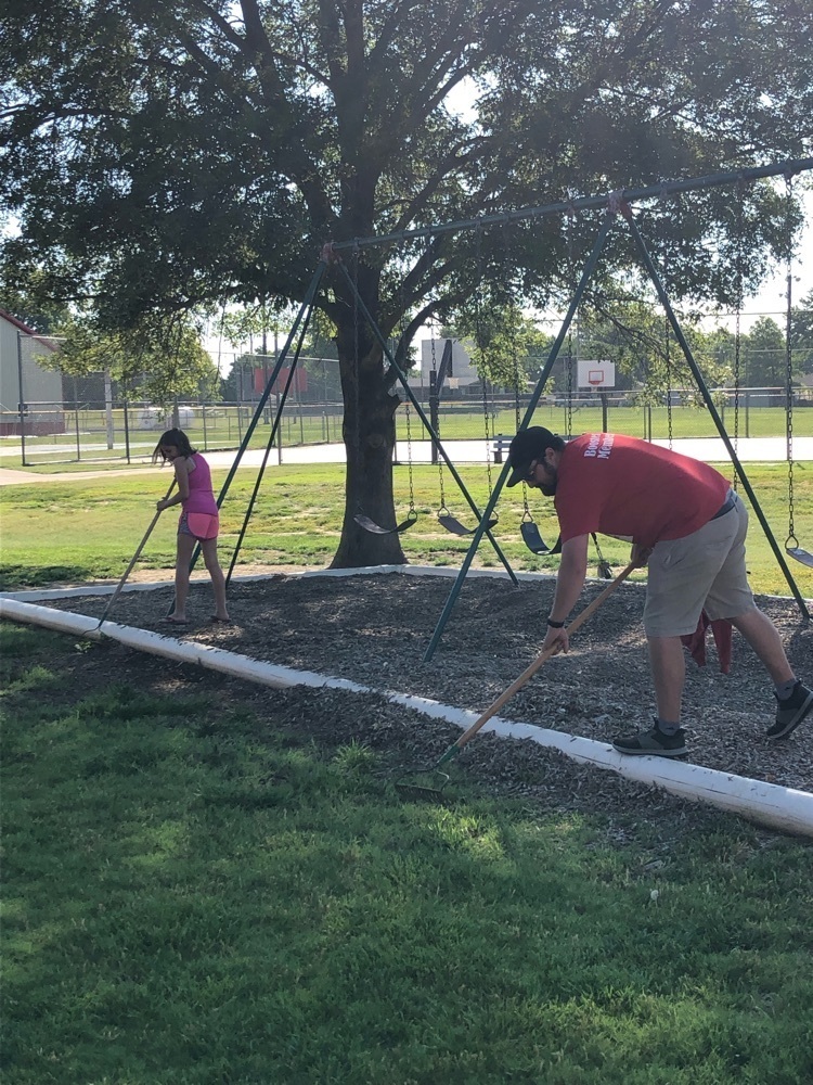 Raking mulch on the playground  