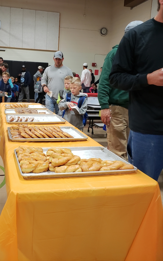 Dads and their children pick out a donut at Donuts with Dad at MP East Elementary