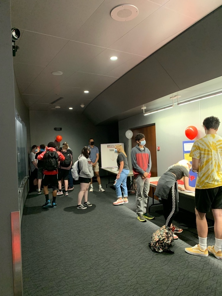 students visiting tables learning about clubs and activities 