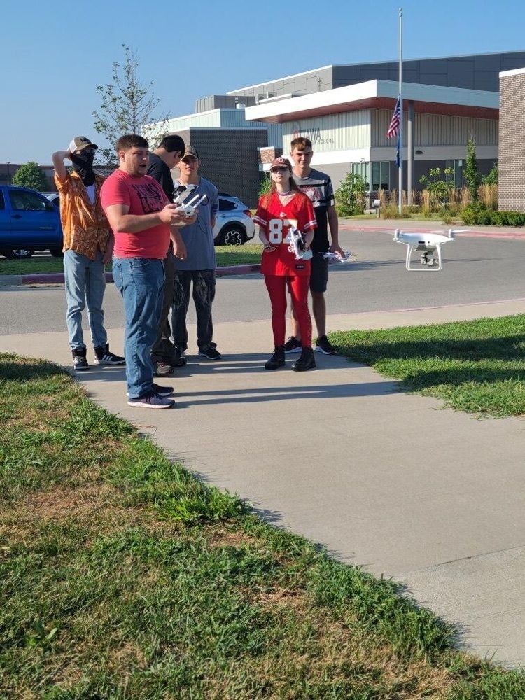 teacher with students and a drone 