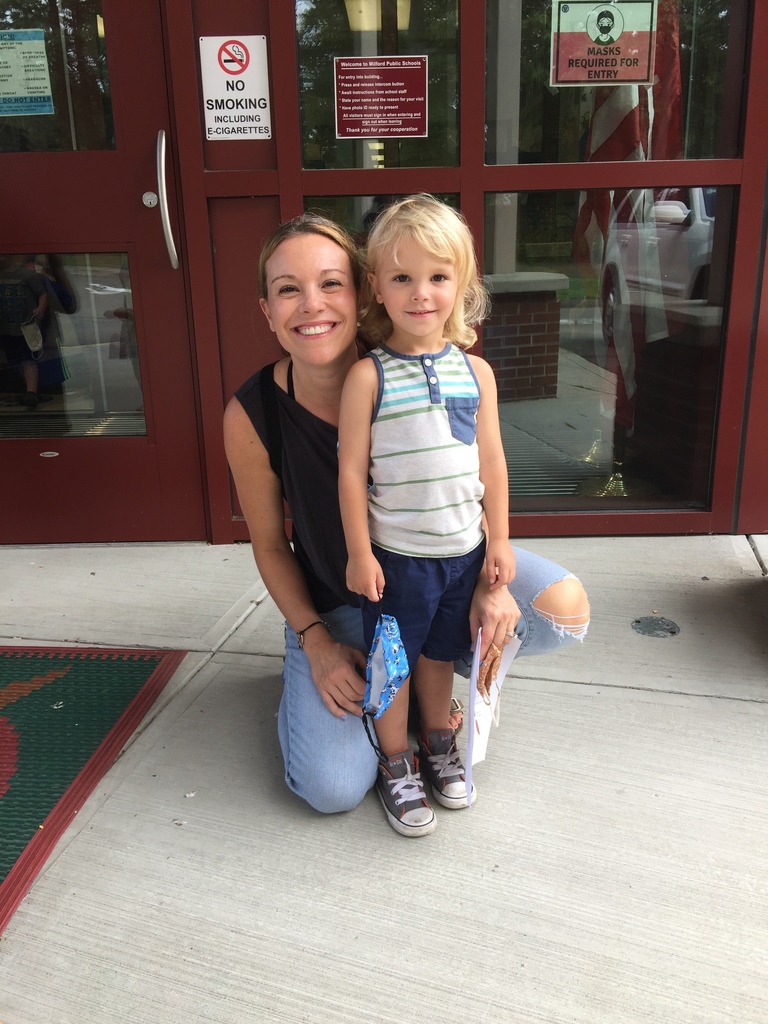 mom and child in front of school