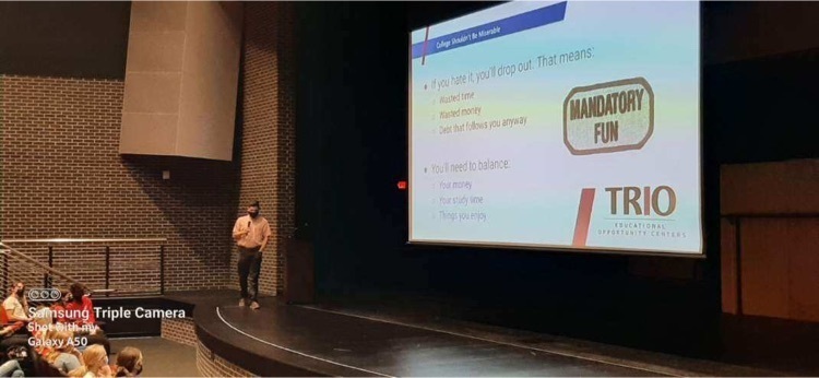 person standing on a stage presenting 