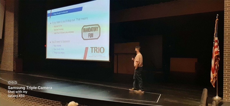 person standing on a stage presenting 