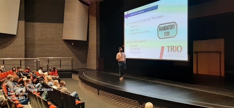 person standing on a stage presenting 