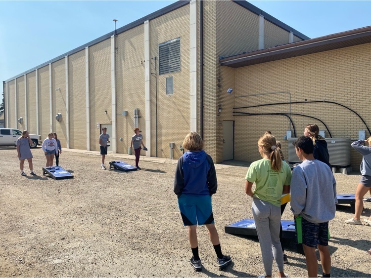 Students playing cornhole during testing breaks