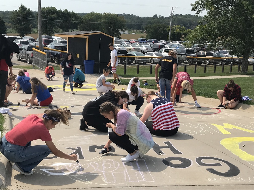 students painting the sidewalk
