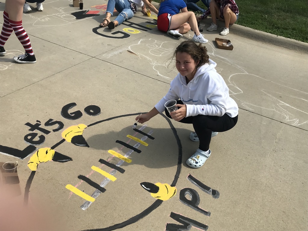 student painting the sidewalk