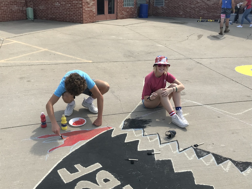 students painting the sidewalk