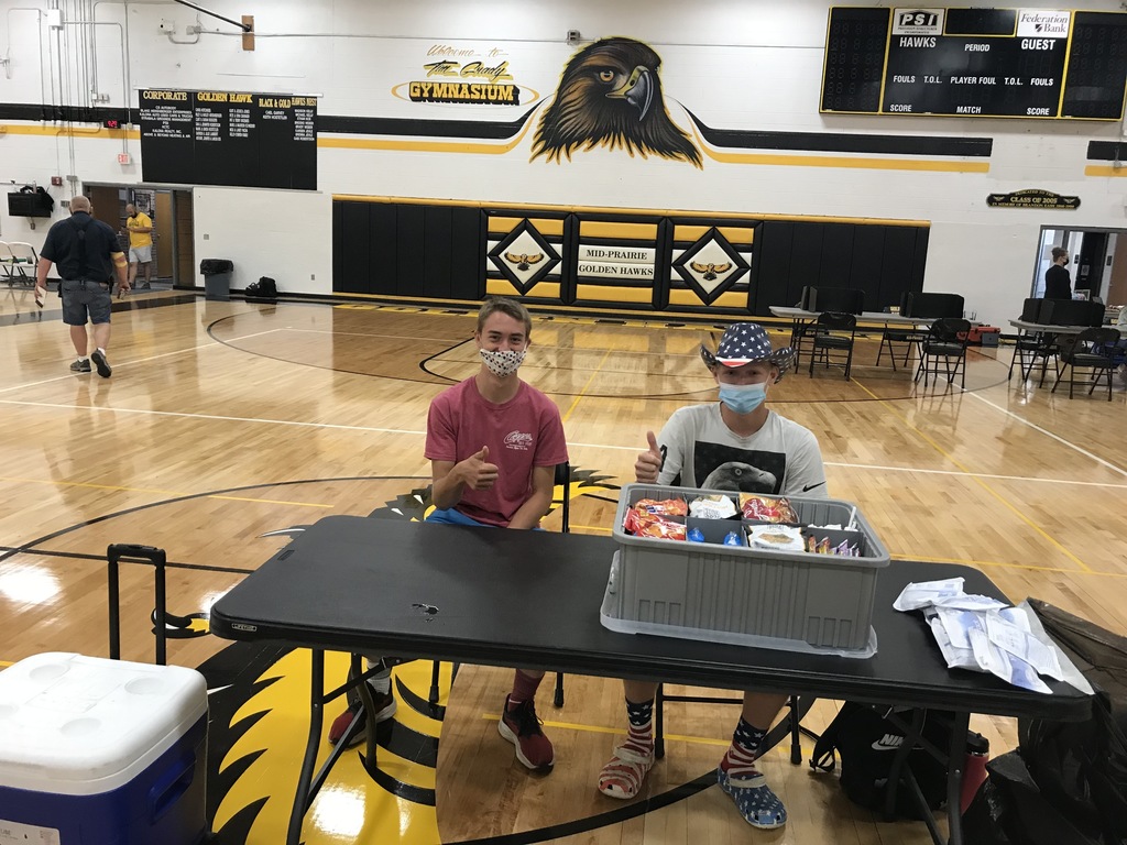 students working at blood drive table