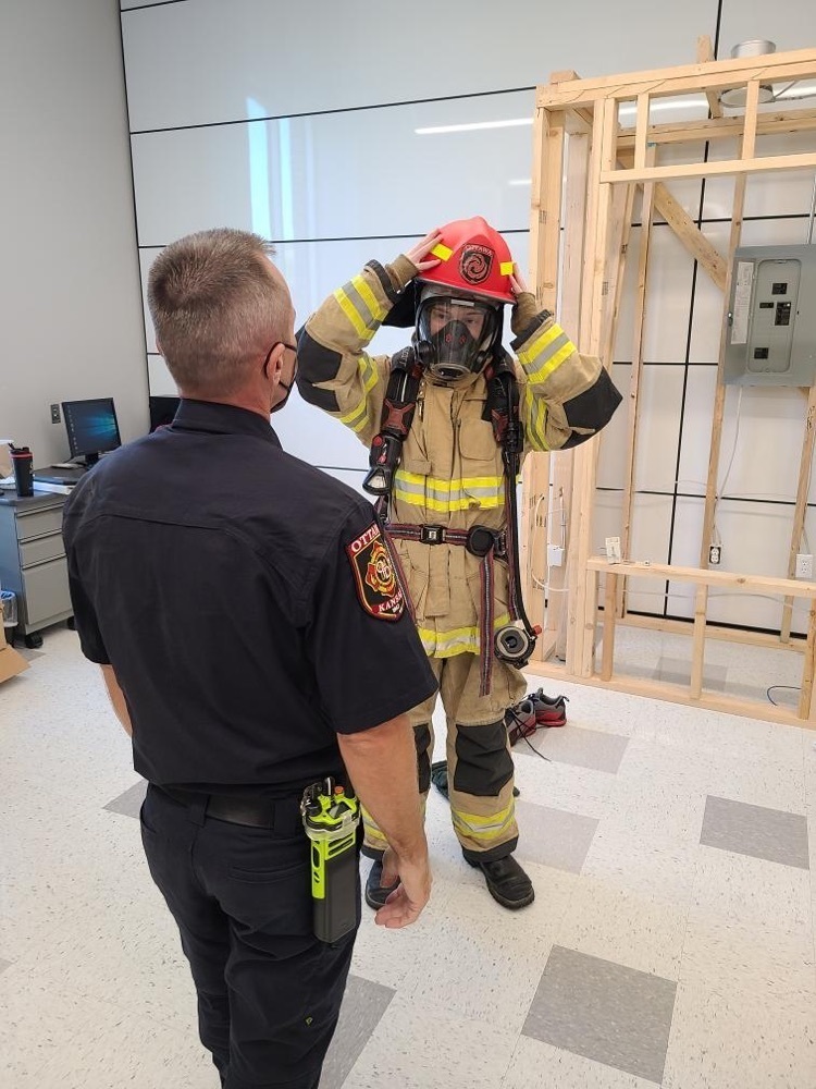 student putting on fire gear