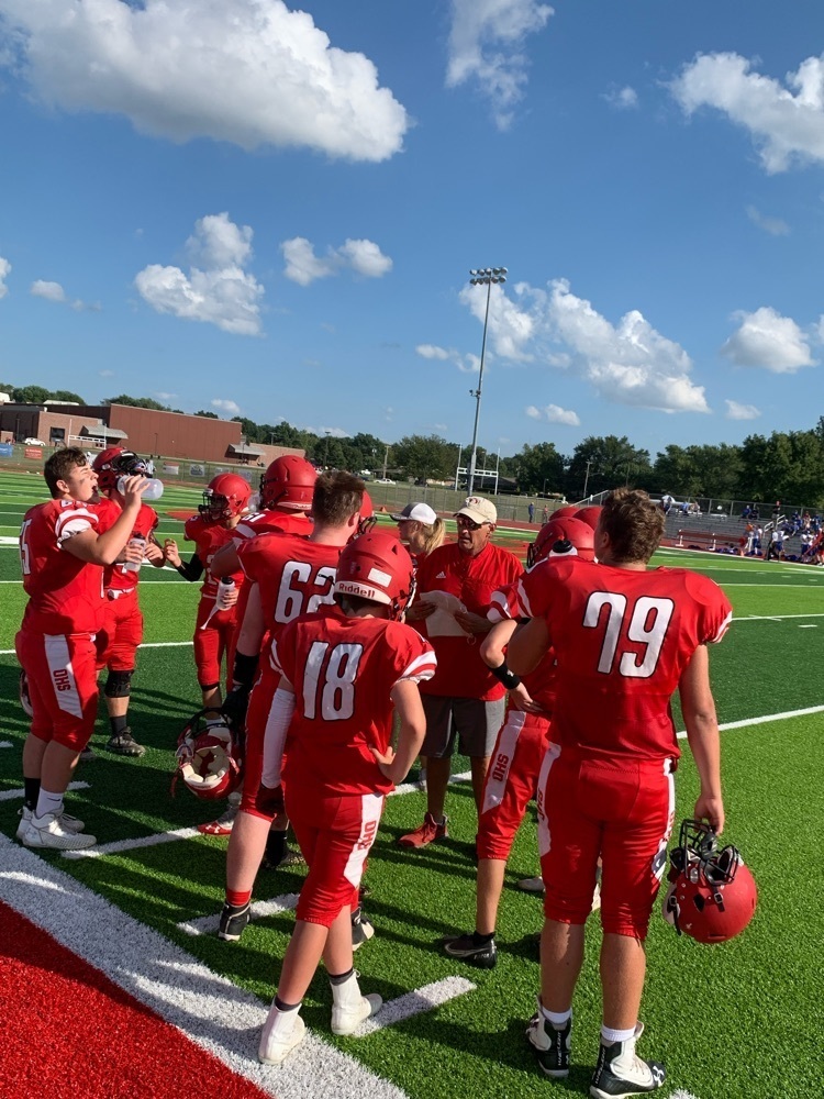 players huddled around coach 