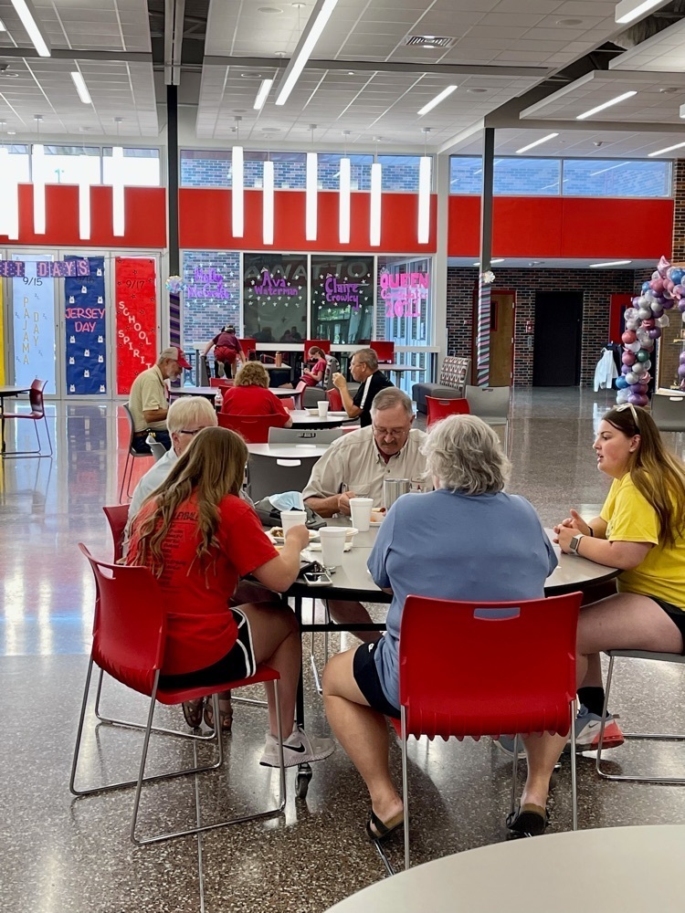 people sitting at a table eating 