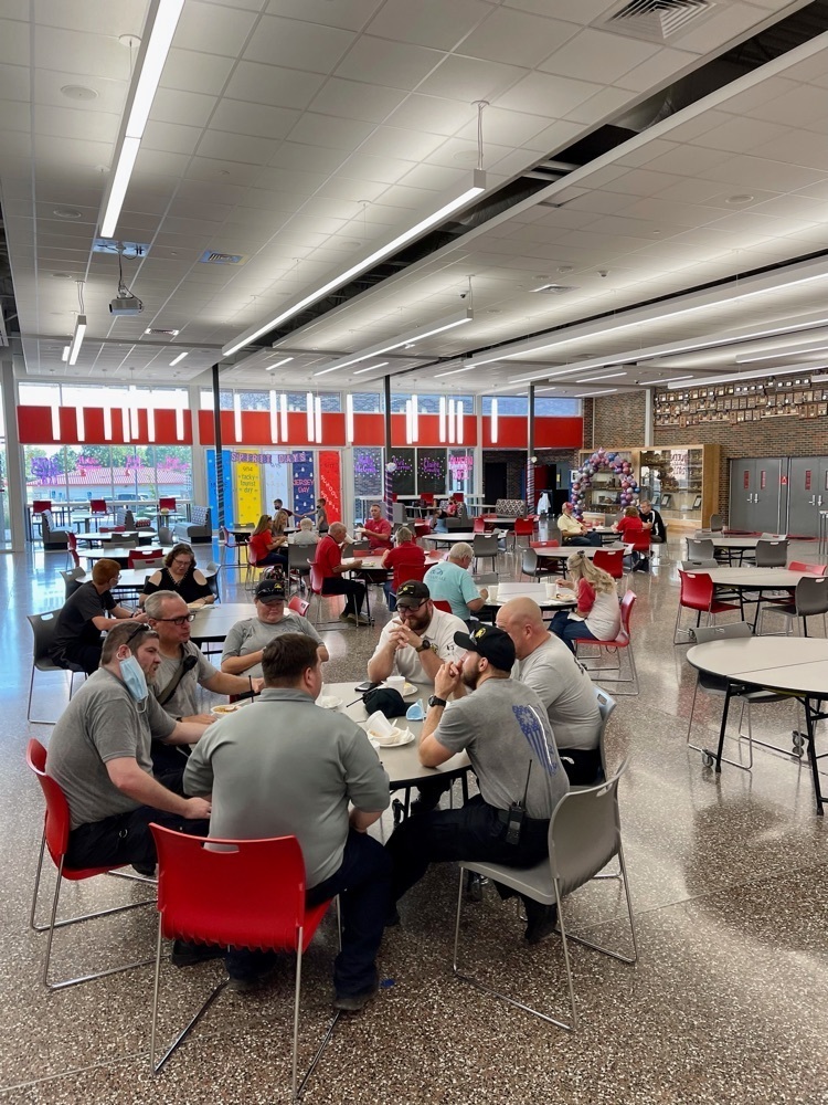 people sitting at a table eating 