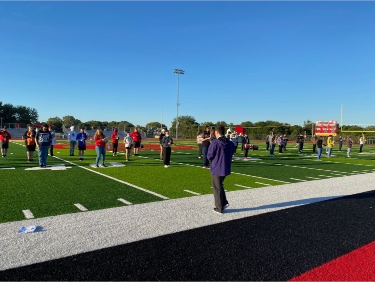 band teacher conducting the marching band 