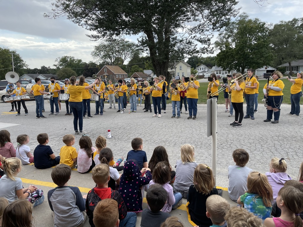 middle school marching band performing for elementary students