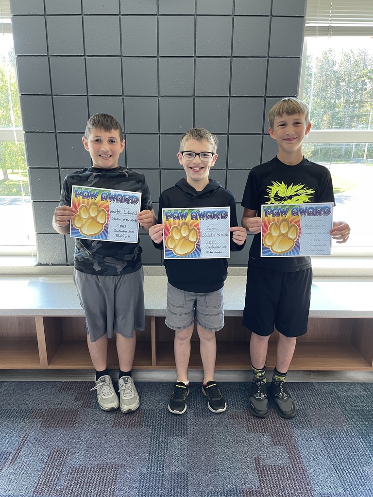 three males holding a paw award