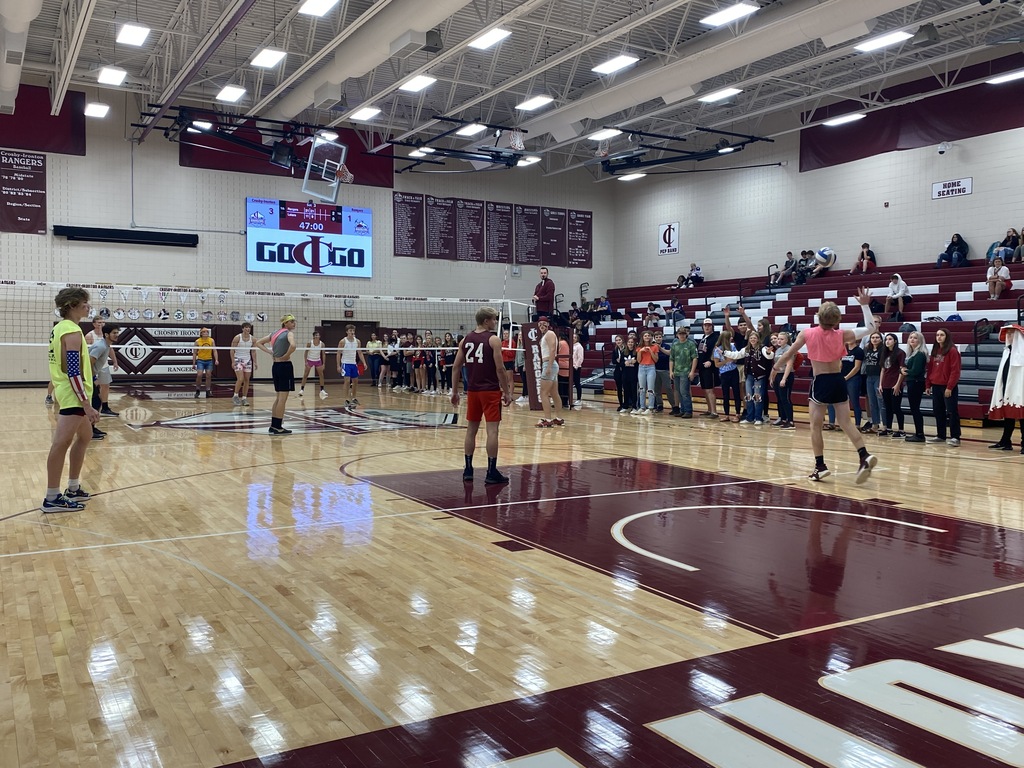 guy in pink serving volleyball