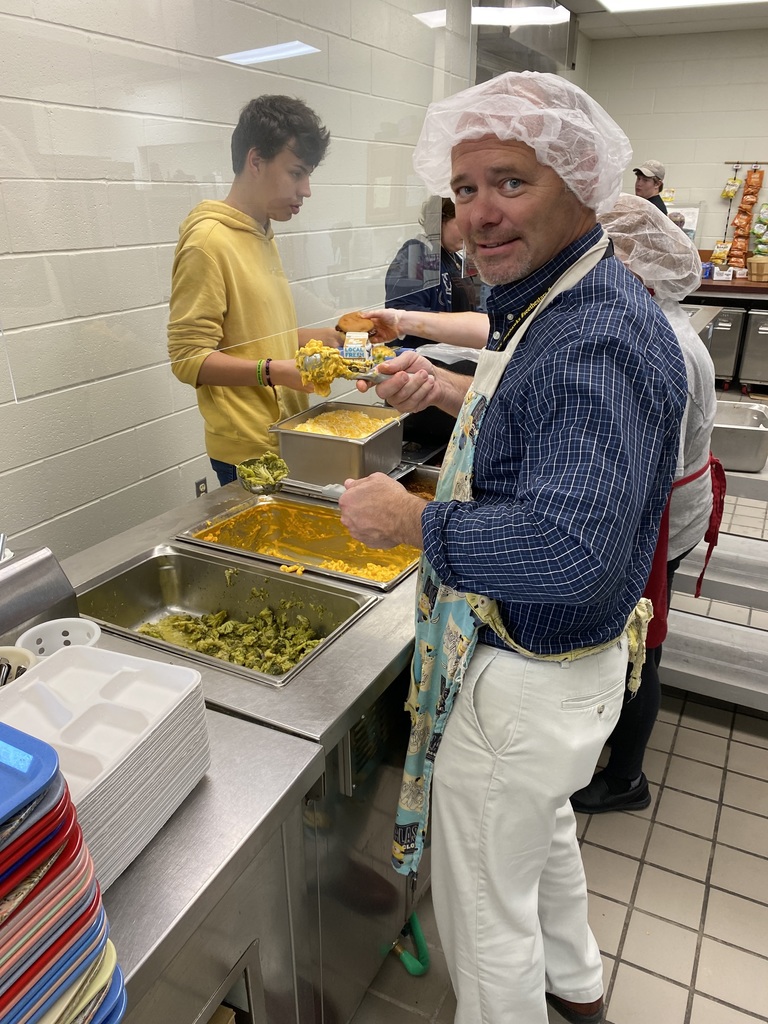 Principal helping to serve lunch to students