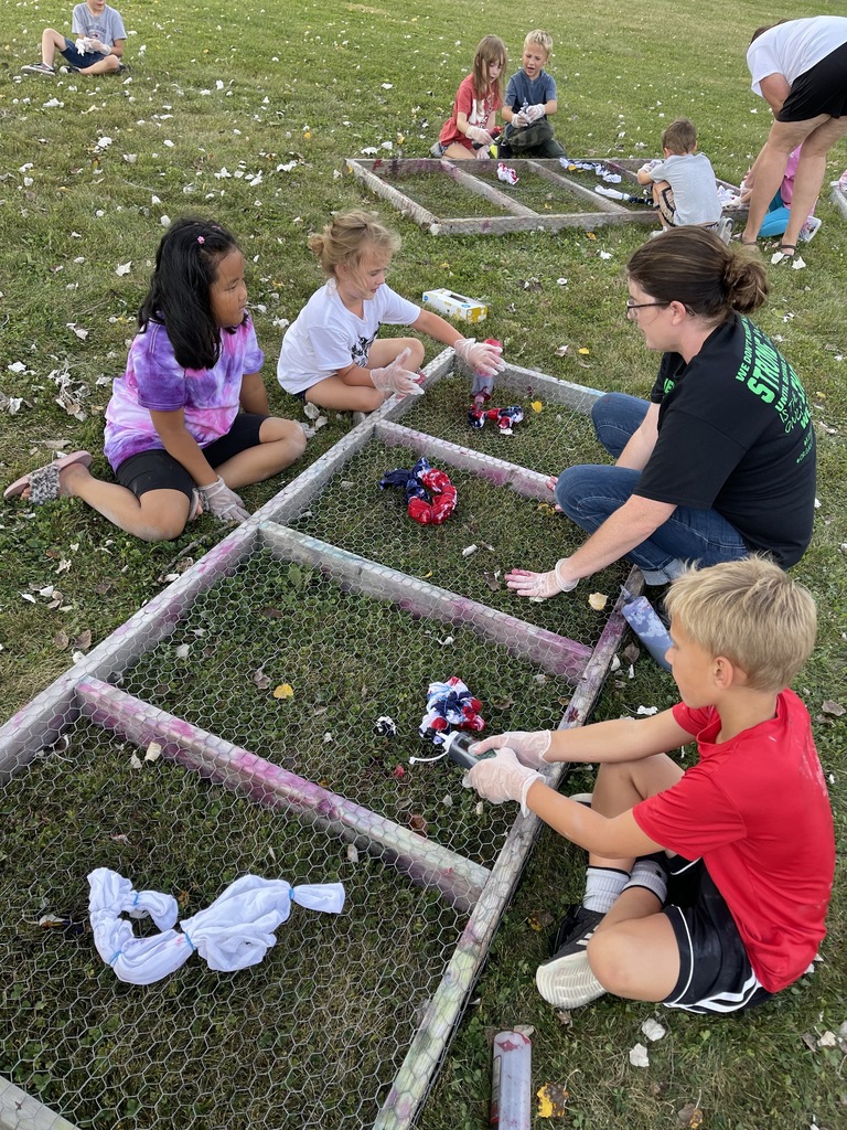 Students tie dying shirts outside