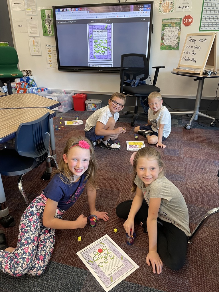 2 girls and 2 boys sitting on the floor