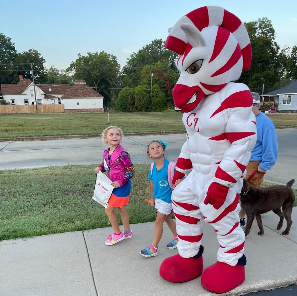 Zeb the Zebra walking with two students