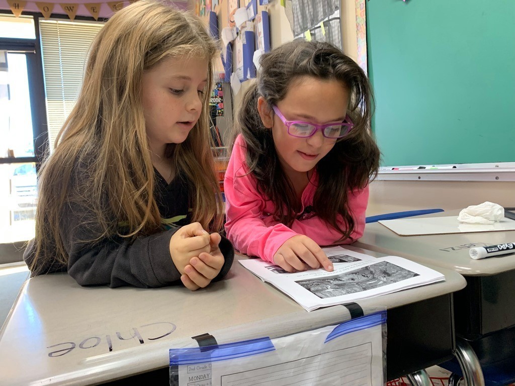 two girls practicing reading outloud