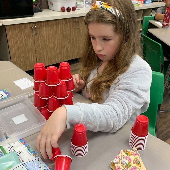 student stacking cups