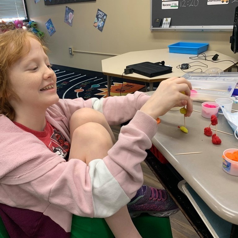 student using play doh and toothpicks