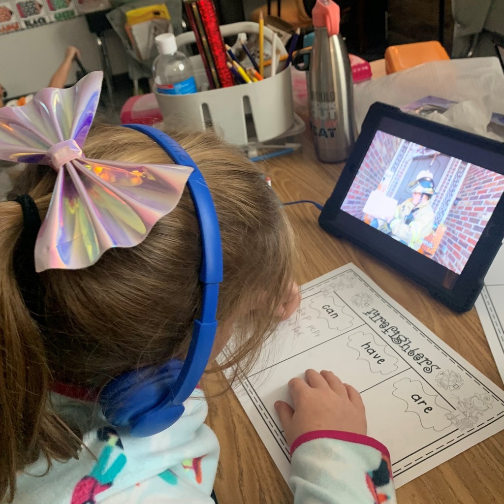 Mrs. Page's 1st grade class watched their iPads as Mr. Page, Tulsa Firemen, read 𝘚𝘵𝘰𝘱 𝘋𝘳𝘰𝘱 𝘢𝘯𝘥 𝘙𝘰𝘭𝘭 a book about Fire Safety.