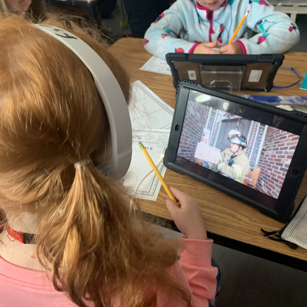 Mrs. Page's 1st grade class watched their iPads as Mr. Page, Tulsa Firemen, read 𝘚𝘵𝘰𝘱 𝘋𝘳𝘰𝘱 𝘢𝘯𝘥 𝘙𝘰𝘭𝘭 a book about Fire Safety. 