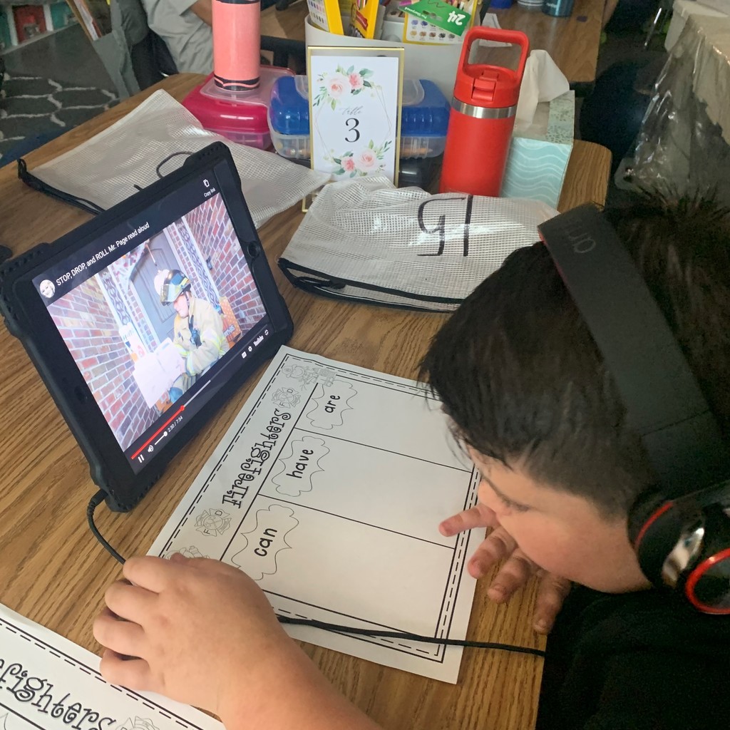 Mrs. Page's 1st grade class watched their iPads as Mr. Page, Tulsa Firemen, read 𝘚𝘵𝘰𝘱 𝘋𝘳𝘰𝘱 𝘢𝘯𝘥 𝘙𝘰𝘭𝘭 a book about Fire Safety. 