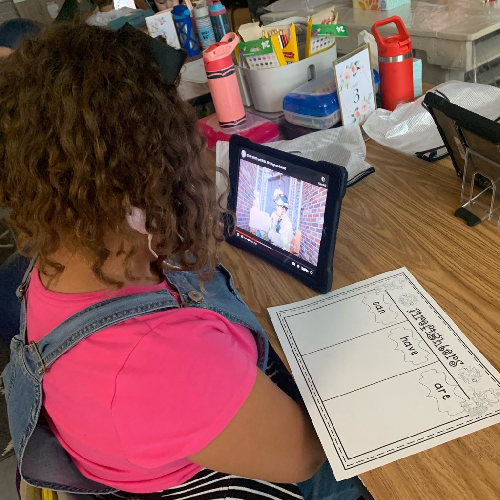 Mrs. Page's 1st grade class watched their iPads as Mr. Page, Tulsa Firemen, read 𝘚𝘵𝘰𝘱 𝘋𝘳𝘰𝘱 𝘢𝘯𝘥 𝘙𝘰𝘭𝘭 a book about Fire Safety.