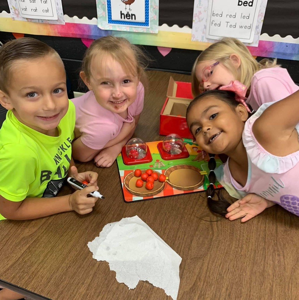 group of students with mini red apples