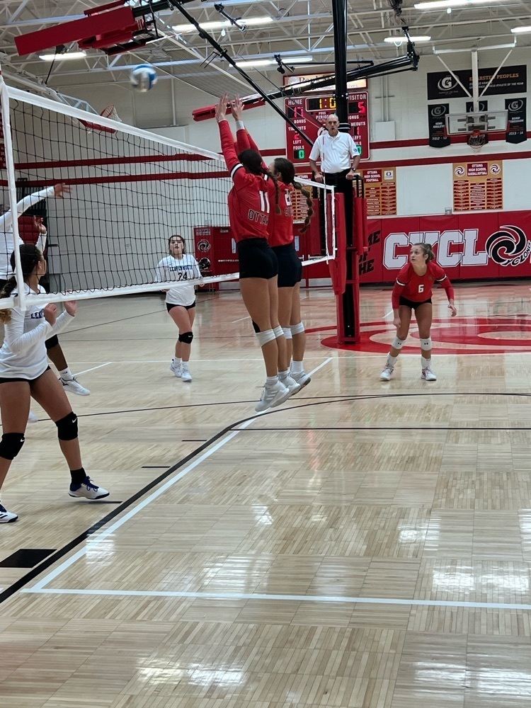 Girls blocking a volleyball 