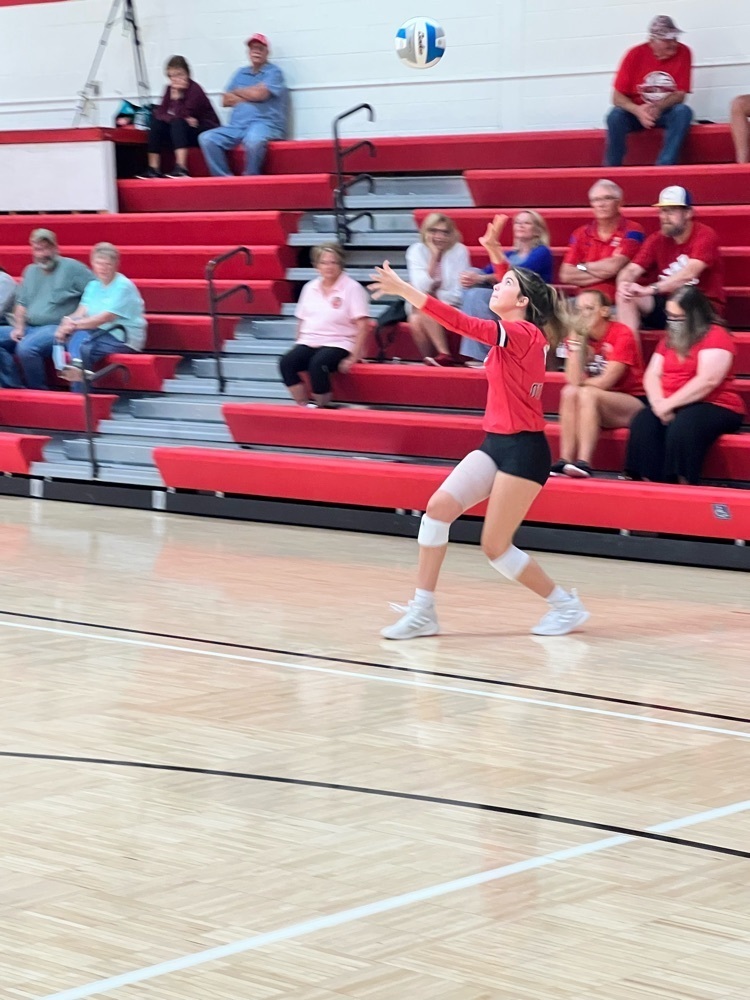 girls serving a volleyball 